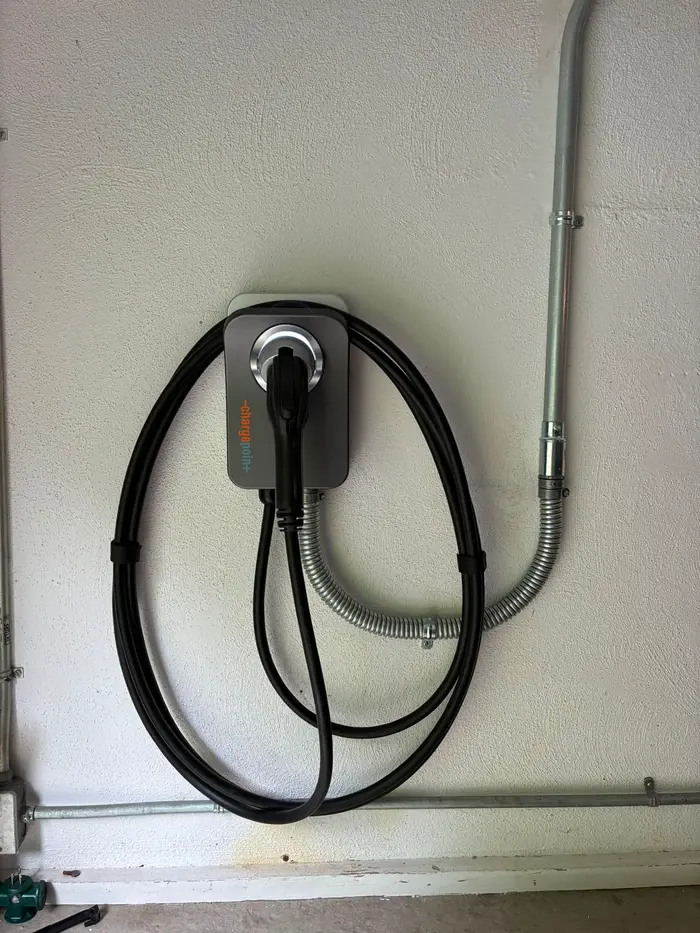 ChargePoint EV charger installed in a residential garage with conduit run