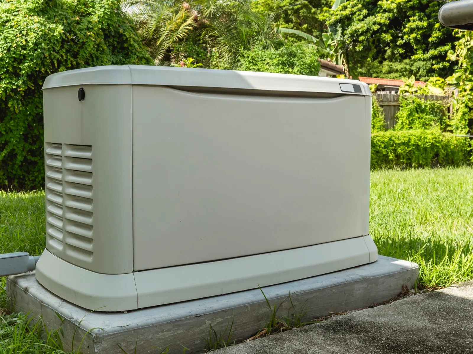 Home standby generator on a concrete pad, a common installation for Norfolk, MA homes
